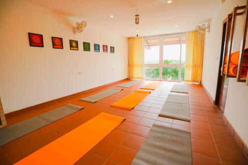 a room with orange mats on the floor and a window at Vaidekam Resorts & Wellness, Kannur in Kannur