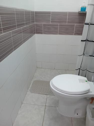 a bathroom with a white toilet in a room at Belaire Bnb one bedroom in Thindigua kiambu road in Kiambu