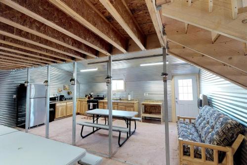 a kitchen and dining room with a table and a refrigerator at Western Town Retreat in Monticello, Utah in Verdure