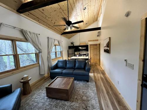a living room with a blue couch and a table at Cozy Rustic Cabin with Hot-Tub Ideal for a Couples Retreat in Illinois in Etherton