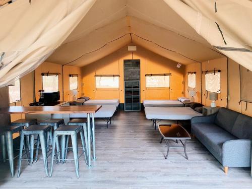 a room with tables and chairs in a tent at Impressive Safari Tent with Barbecue in Staples, Texas in Staples