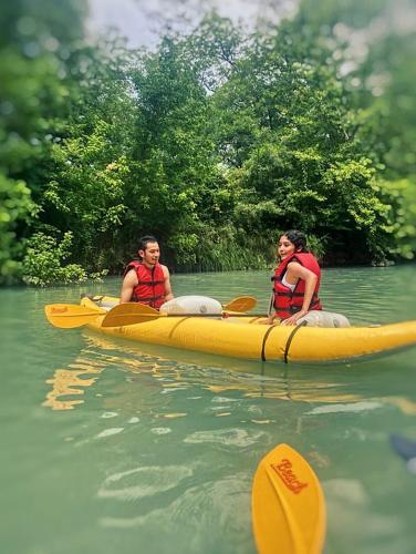 two people in a yellow kayak in the water at Impressive Safari Tent with Barbecue in Staples, Texas in Staples