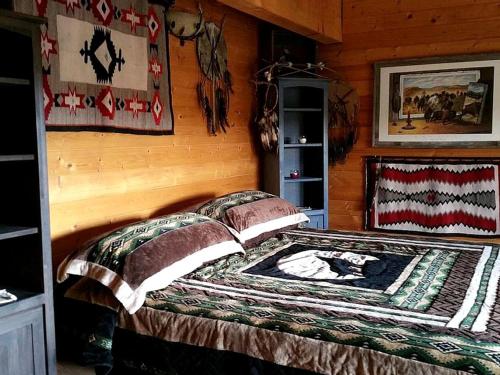 a bedroom with a bed in a log cabin at Spacious, Inviting Log Cabin Encircled by Wildlife in Utah in Long Valley Junction