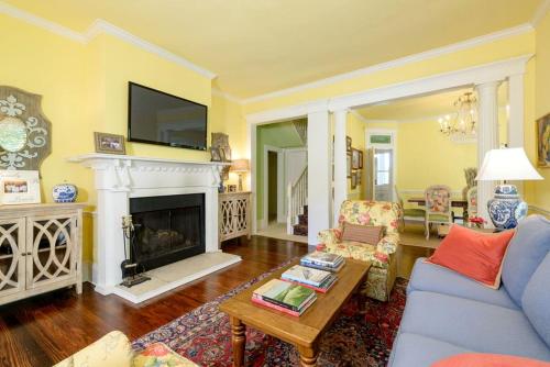 Una sala de estar con un sofá azul y una chimenea. en Incredible Villa Rental for Groups with Pool near Mt Vernon, Texas, en Hopewell