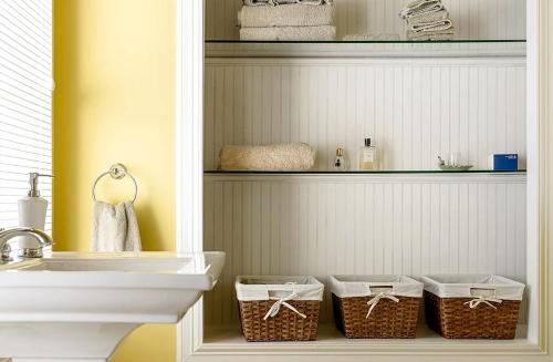 a bathroom with baskets on a shelf next to a sink at Incredible Villa Rental for Groups with Pool near Mt Vernon, Texas in Hopewell