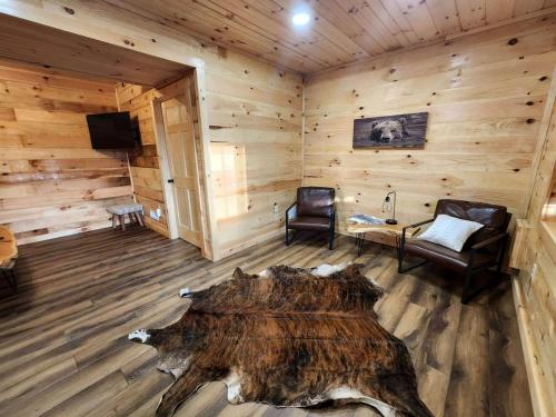 a room with a large tree stump in the middle of a cabin at Lakeview Cabin by Tappan Lake, Perfect for Groups with Hot-Tub in Ohio in Deersville