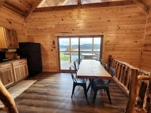 a dining room with a table and chairs in a cabin at Lakeview Cabin by Tappan Lake, Perfect for Groups with Hot-Tub in Ohio in Deersville