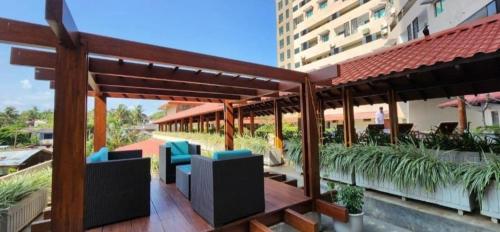 a patio with blue chairs on a building at Ocean View Condos in Galle