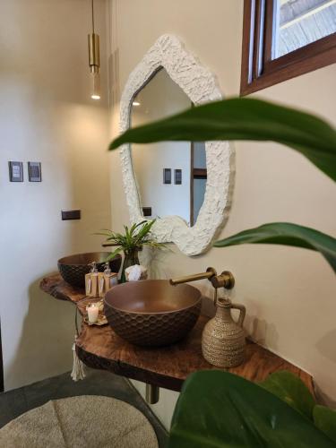 a bathroom with two sinks and a mirror at Prana Siargao Resort in General Luna