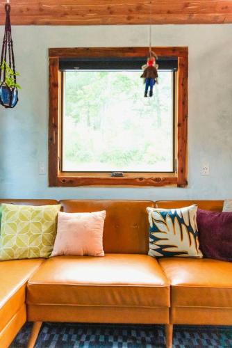 a couch sitting in a room with a window at Charming Pet-Friendly Cabin with Stunning Mountain Views in Chattanooga, Tennessee in Whitwell