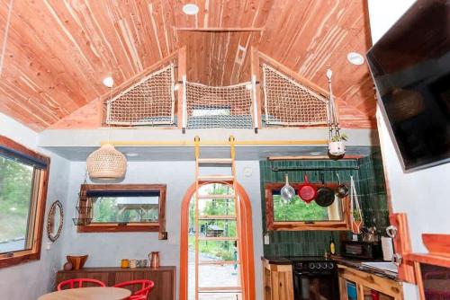 an interior view of a kitchen in a tiny house at Charming Pet-Friendly Cabin with Stunning Mountain Views in Chattanooga, Tennessee in Whitwell