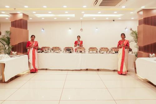 a group of three women standing in a waiting room at Hotel Ratneswar in Alīpur Duār