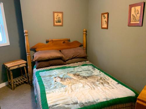 a bedroom with a bed with a painting of a wolf at Waterfront Lodge Ideal for Water Activities in Wilmington, NY in Wilmington