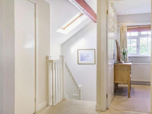 a hallway with white walls and stairs with a window at 2 Bed in Llangattock BN228 in Llangattock