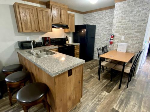 a kitchen with a sink and a table with chairs at Unique Cottage Close to Fantastic Hiking Trails in Dunnellon, Florida in Dunnellon