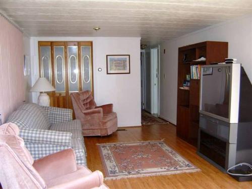 a living room with a couch and a refrigerator at Cozy Lakeside Vacation Rental near St David, Maine in Lavertue