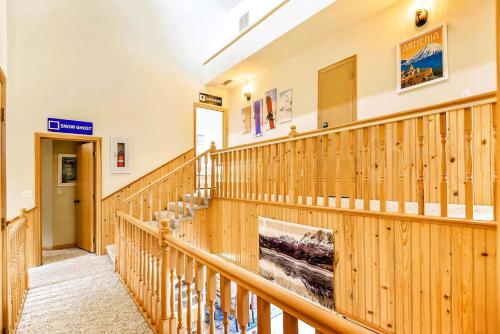 a staircase in a building with wooden walls at High-altitude Hideaway: Large Rental on Schweitzer Mountain with Views and Hot Tub in Bronx