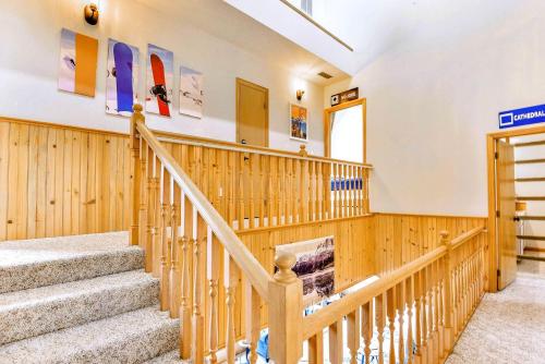 a set of stairs in a building with wooden walls at High-altitude Hideaway: Large Rental on Schweitzer Mountain with Views and Hot Tub in Bronx
