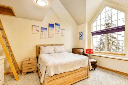 a bedroom with a bed and a large window at High-altitude Hideaway: Large Rental on Schweitzer Mountain with Views and Hot Tub in Bronx