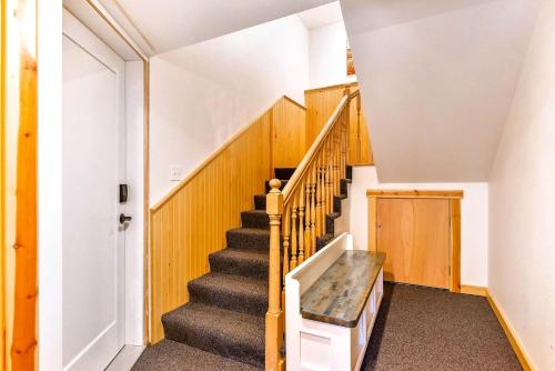 a staircase in a house with a stair case at High-altitude Hideaway: Large Rental on Schweitzer Mountain with Views and Hot Tub in Bronx