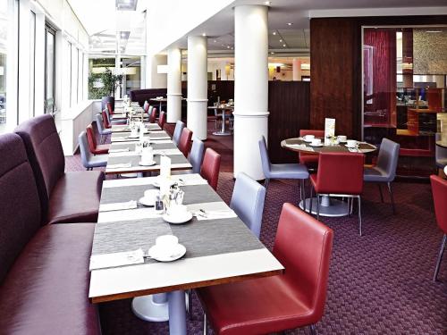 a row of tables and chairs in a restaurant at Novotel Sheffield Centre in Sheffield
