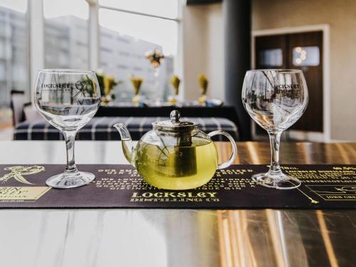 a tray with three wine glasses on a table at Novotel Sheffield Centre in Sheffield