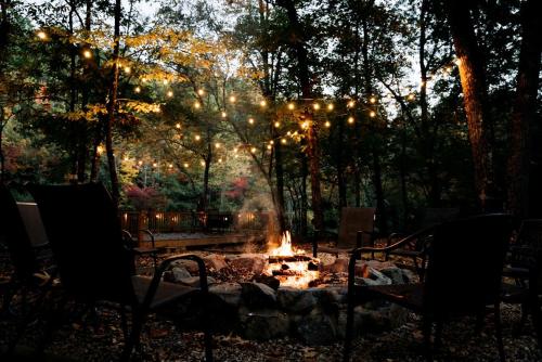 a fire pit in a yard with chairs and lights at Fantastic Cabin with Fire Pit, Hot-tub and Fireplace in Sautee Nacoochee, Georgia in Aerial