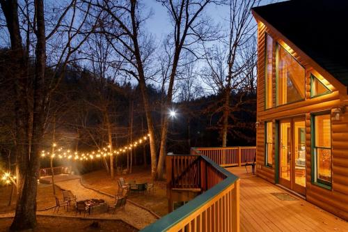 a house with a deck with lights on it at Fantastic Cabin with Fire Pit, Hot-tub and Fireplace in Sautee Nacoochee, Georgia in Aerial