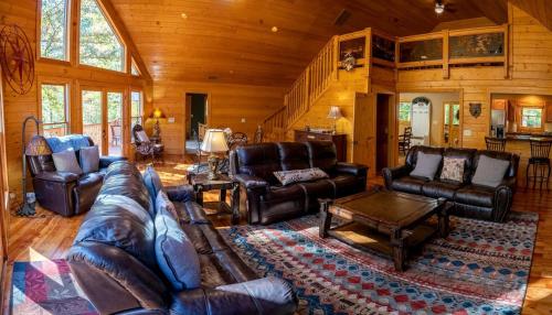 a large living room with leather furniture in a cabin at Fantastic Cabin with Fire Pit, Hot-tub and Fireplace in Sautee Nacoochee, Georgia in Aerial