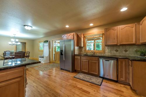 a kitchen with stainless steel appliances and wooden cabinets at Fantastic Cabin with Fire Pit, Hot-tub and Fireplace in Sautee Nacoochee, Georgia in Aerial