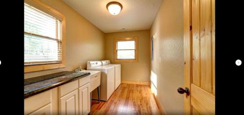 a kitchen with a washer and dryer and a window at Fantastic Cabin with Fire Pit, Hot-tub and Fireplace in Sautee Nacoochee, Georgia in Aerial