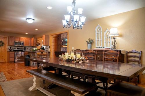a kitchen and dining room with a large wooden table at Fantastic Cabin with Fire Pit, Hot-tub and Fireplace in Sautee Nacoochee, Georgia in Aerial