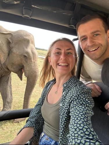 a man and a woman in a car with an elephant at EverGreen Resort Udawalawe in Udawalawe