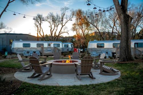 a patio with chairs and a fire pit and two rvs at Modern Airstream Stay in Downtown Prescott AZ Near Whiskey Row in Prescott