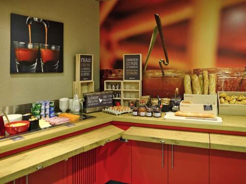 a kitchen with a counter with some food on it at ibis Avignon Centre Pont De L'Europe in Avignon
