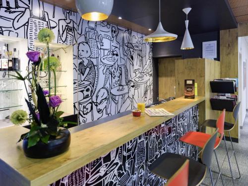 a bar with a black and white patterned wall at ibis Avignon Centre Pont De L'Europe in Avignon