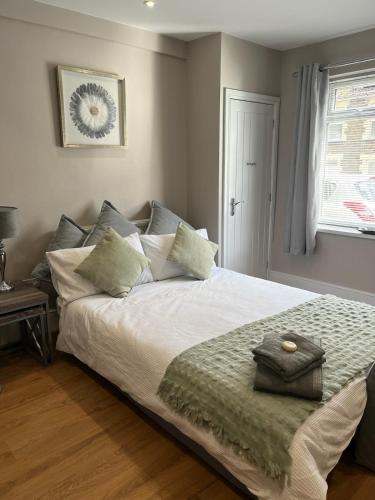 a bedroom with a white bed with pillows and a window at Flat in Maerdy in Maerdy