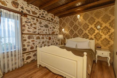 a bedroom with a white bed and a window at Harmony Butik Otel in Alanya