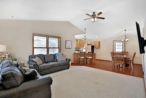 a living room with two couches and a kitchen at Lakefront Cottage Fully Equipped with Excellent Location in Saint Croix Falls, Wisconsin in Saint Croix Falls