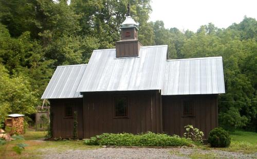 a barn with a clock tower on top of it at Unique Accommodation with Sauna for a Glamping Experience near Nantahala River, North Carolina in Marble