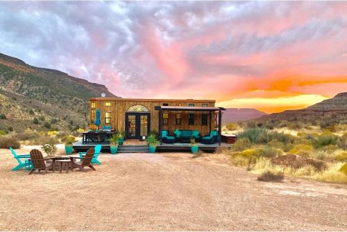 a house in the desert with a table and chairs at The Ark Tiny House near Zion National Park, Utah in Virgin