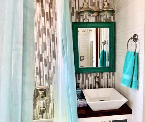a bathroom with a sink and a mirror at The Ark Tiny House near Zion National Park, Utah in Virgin