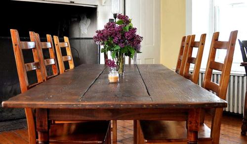 a wooden table with a vase of flowers on it at Private Bed and Breakfast Accommodation for Two near Doylestown, Pennsylvania in Buckingham