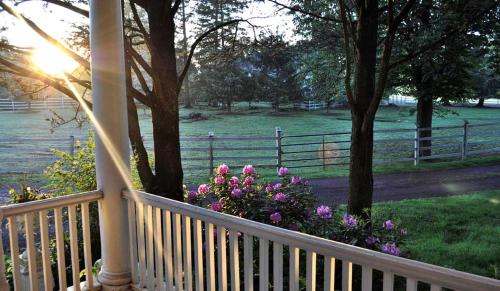 a porch with a fence and flowers on it at Private Bed and Breakfast Accommodation for Two near Doylestown, Pennsylvania in Buckingham