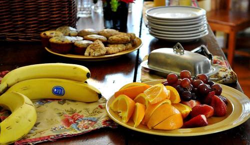 a table with plates of fruit and plates of pastries at Private Bed and Breakfast Accommodation for Two near Doylestown, Pennsylvania in Buckingham