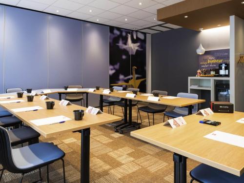 a conference room with wooden tables and chairs at ibis Lyon Part Dieu Les Halles in Lyon