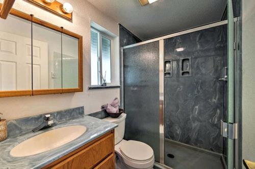 a bathroom with a shower and a sink and a toilet at Beautiful Cabin Rental with Private Hot Tub on the Skykomish River in Washington in Index