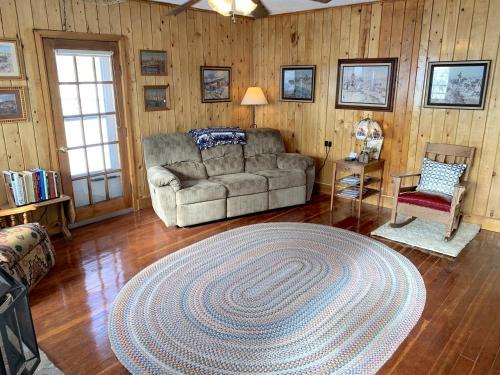 - un salon avec un canapé et un grand tapis dans l'établissement Stunning Cottage with Fire Pit in Saratoga, Wyoming, à Encampment