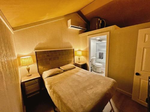 a small bedroom with a bed and a bathroom at Rest and Relax in Texas in this Great Safari Tent Getaway in Cibolo in Marion