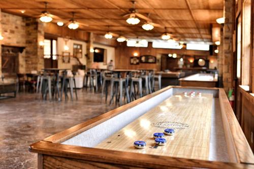 a ping pong table in a restaurant with chairs at Rest and Relax in Texas in this Great Safari Tent Getaway in Cibolo in Marion